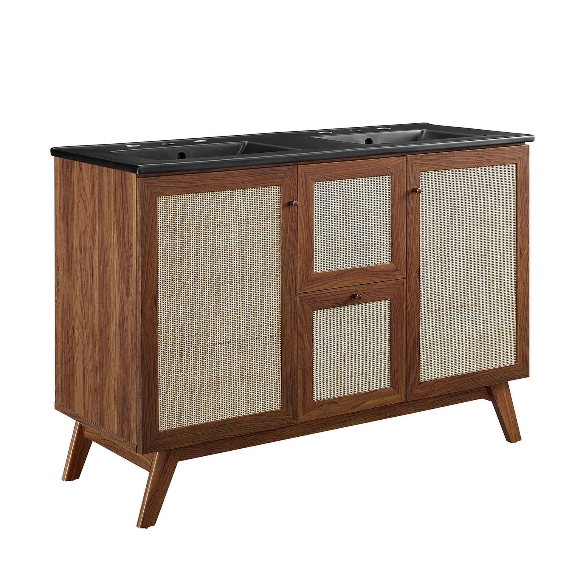 Walnut bathroom vanity with black dual-sink countertop, woven rattan cabinet doors & mid-century angled legs.
