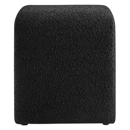 Black boucle fabric-covered cube stool with rounded corners and small feet.