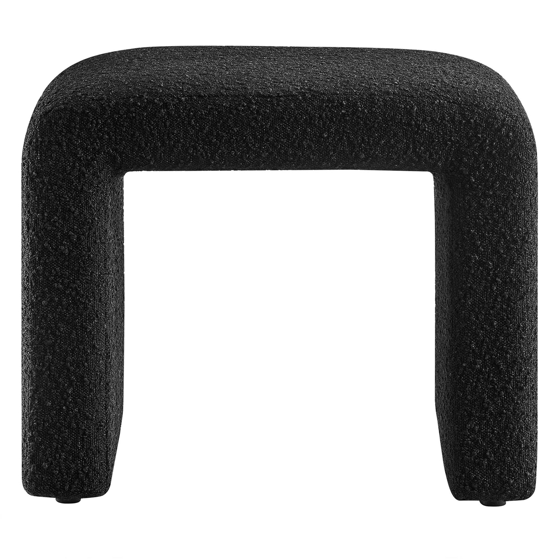 Black boucle fabric waterfall stool with a curved seat edge and short legs.