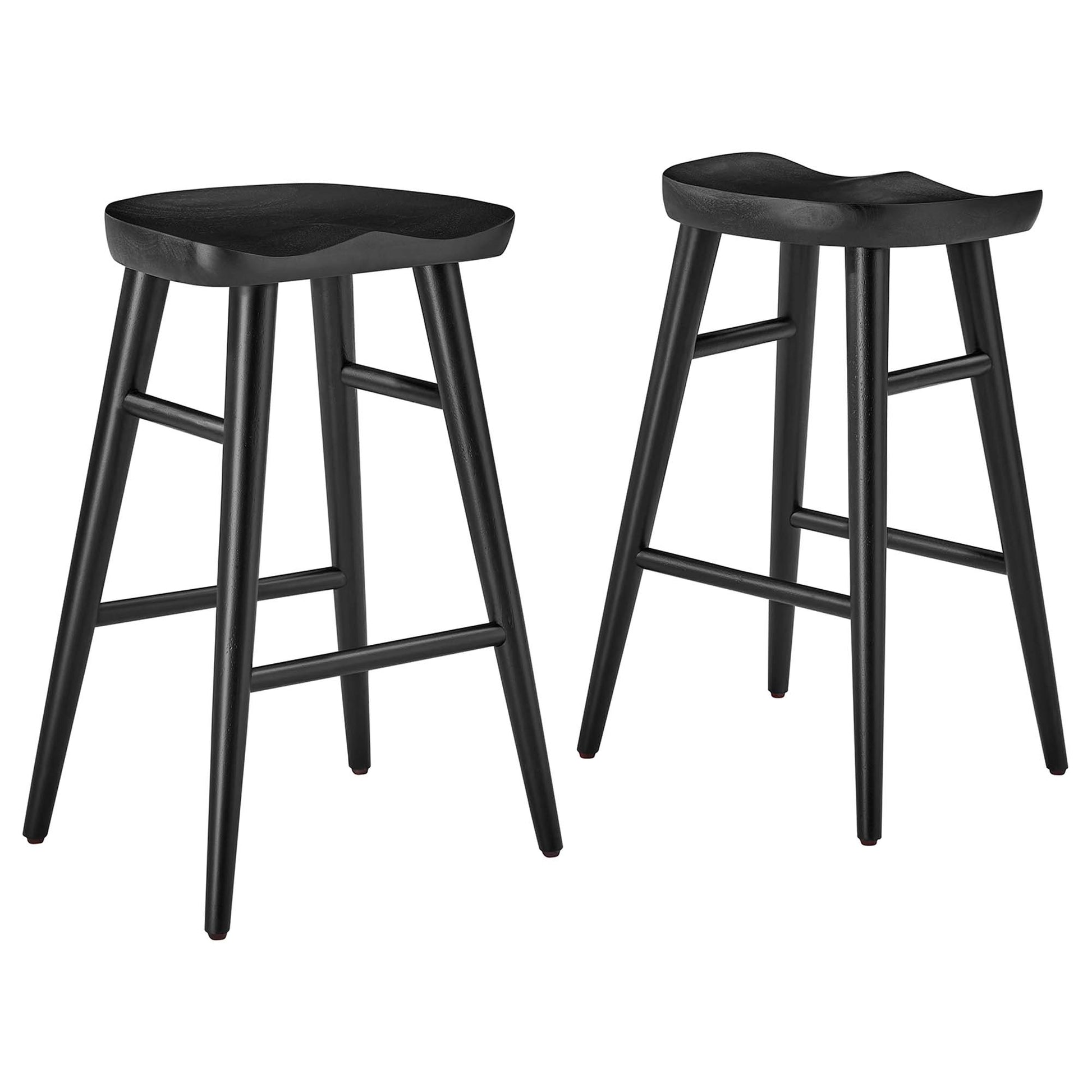 Pair of black backless saddle-seat counter stools with curved seats, ladder-style footrests and tapered legs.