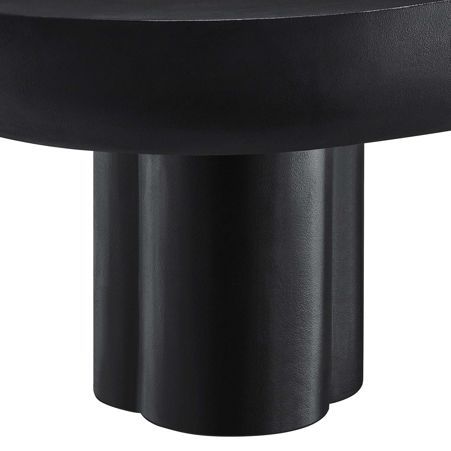 Close-up of a black matte metal pedestal base with three rounded columns supporting an oval concrete coffee table top.