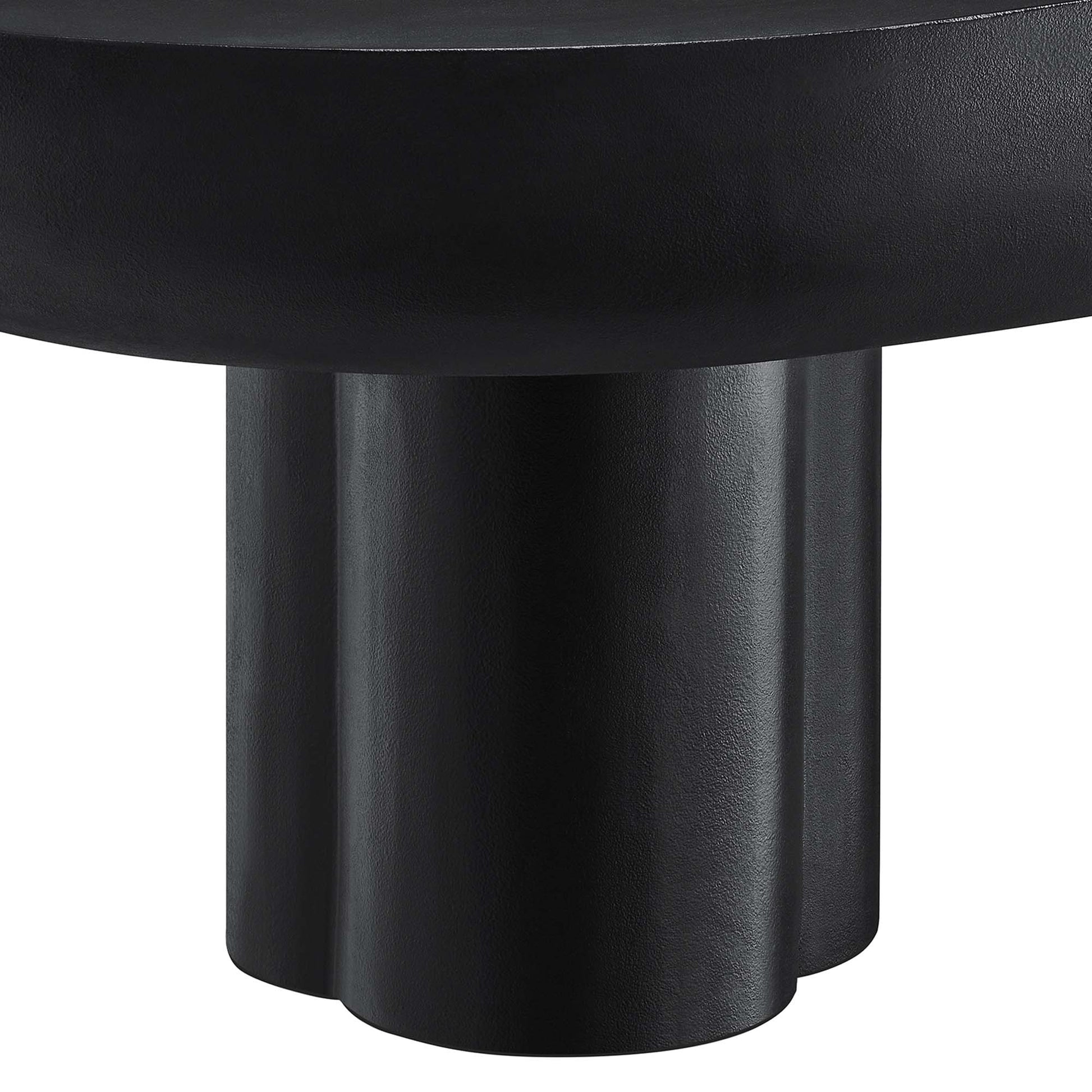 Close-up of a black matte metal pedestal base with three rounded columns supporting an oval concrete coffee table top.