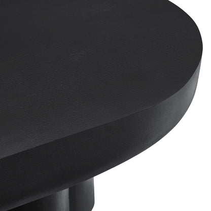 Black oval concrete coffee table with a smooth surface and minimalist design.