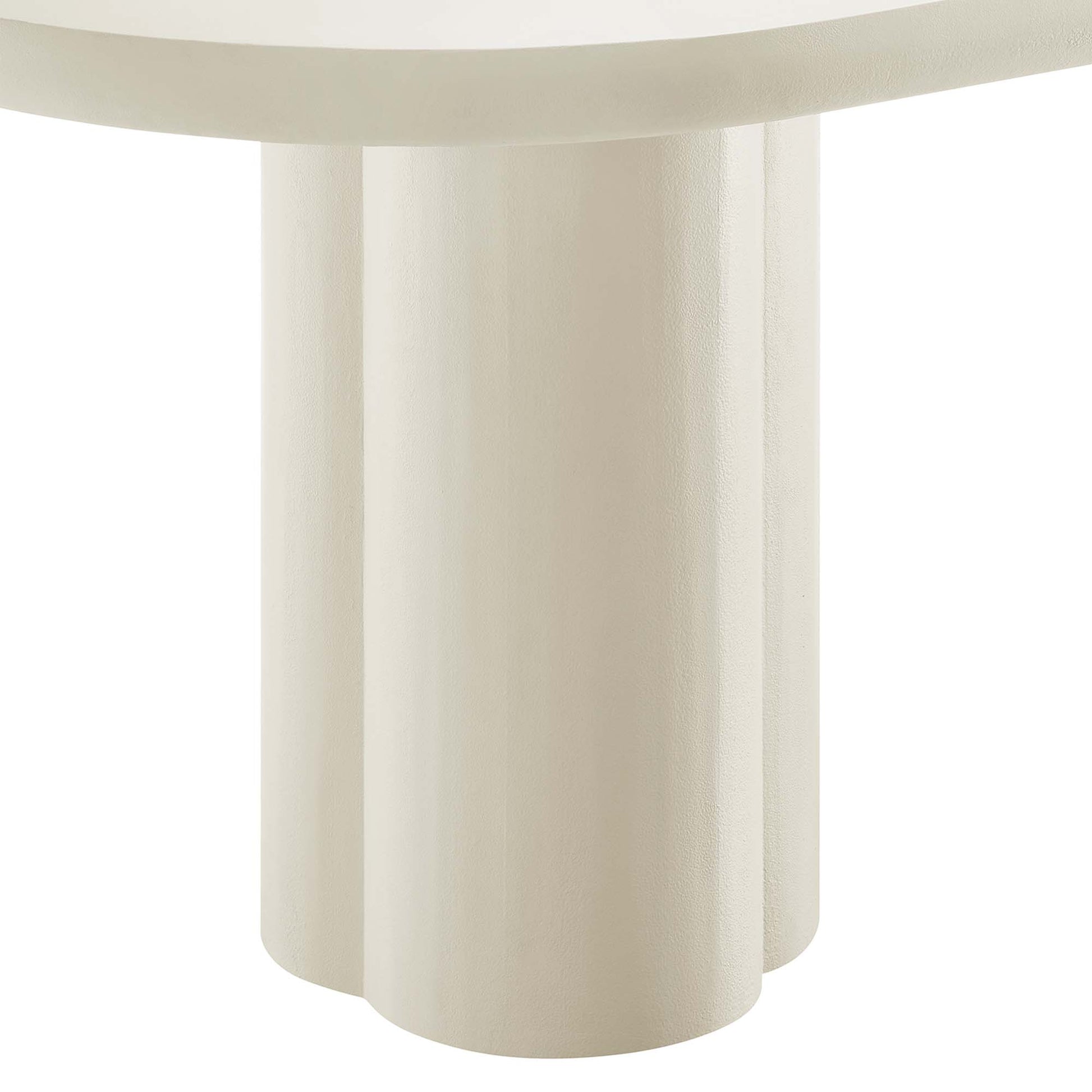 White oval concrete dining table with a sculptural base of three chunky cylindrical legs.