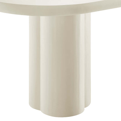 White oval concrete dining table with a sculptural base of three chunky cylindrical legs.