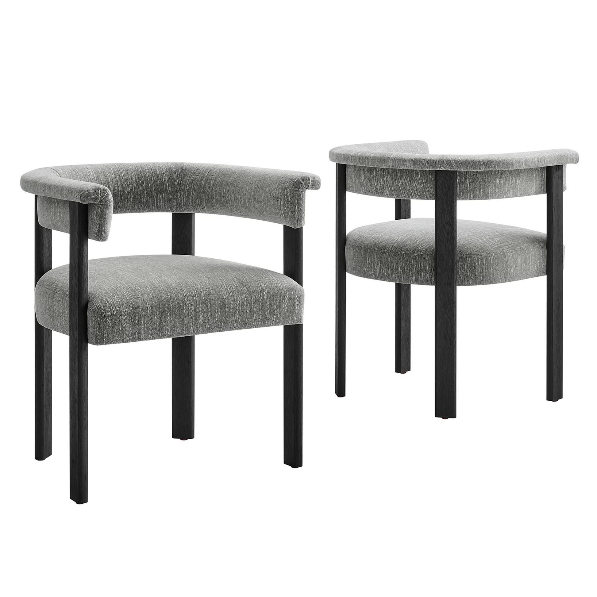 Pair of grey fabric-upholstered barrel dining chairs on black wooden legs.