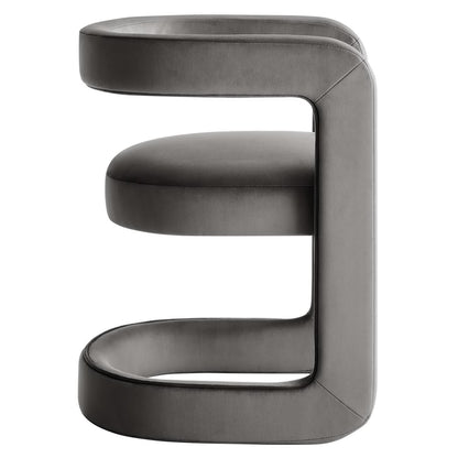 Grey velvet sculptural barrel accent chair with a continuous C-shaped frame and rounded cushions, modern contemporary seating.
