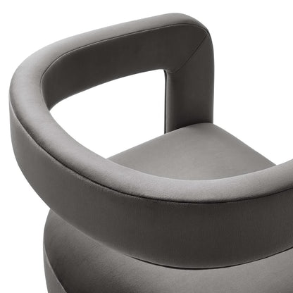 Gray velvet barrel accent chair with wraparound circular armrest and cushioned seat, modern contemporary design.