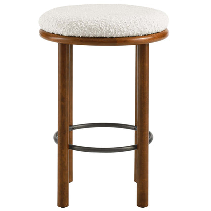 Pair of walnut-finish wood counter stools with ivory boucle upholstered seats; four legs with a metal brace, mid-century style.