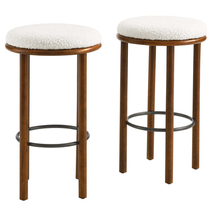 Pair of walnut-stained wooden stools with round ivory boucle upholstered seats & black metal ring footrests.