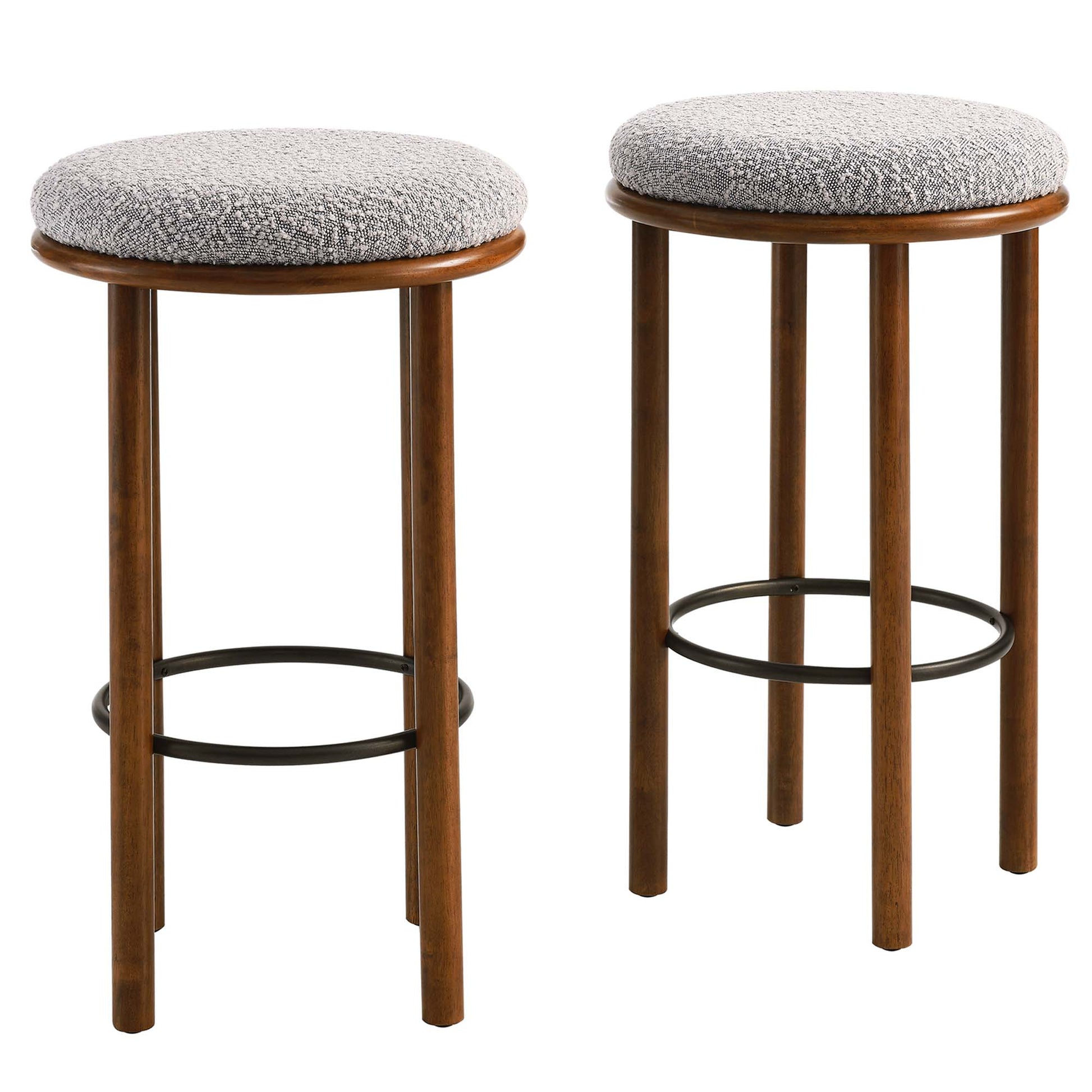 Pair of walnut wood bar stools with round taupe textured fabric seats & black circular footrests.