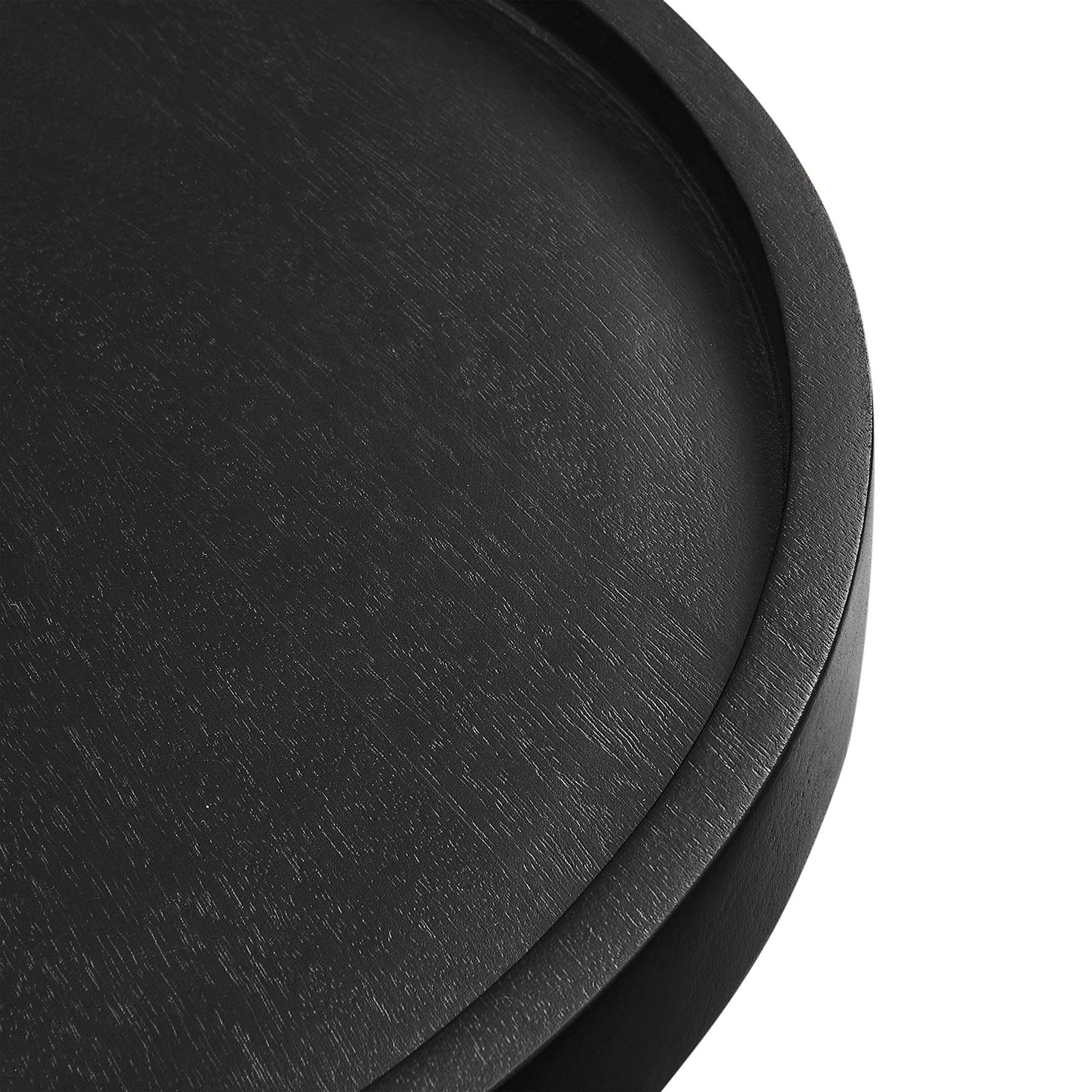 Black round wood side table; close-up showing wood grain on the circular tabletop.