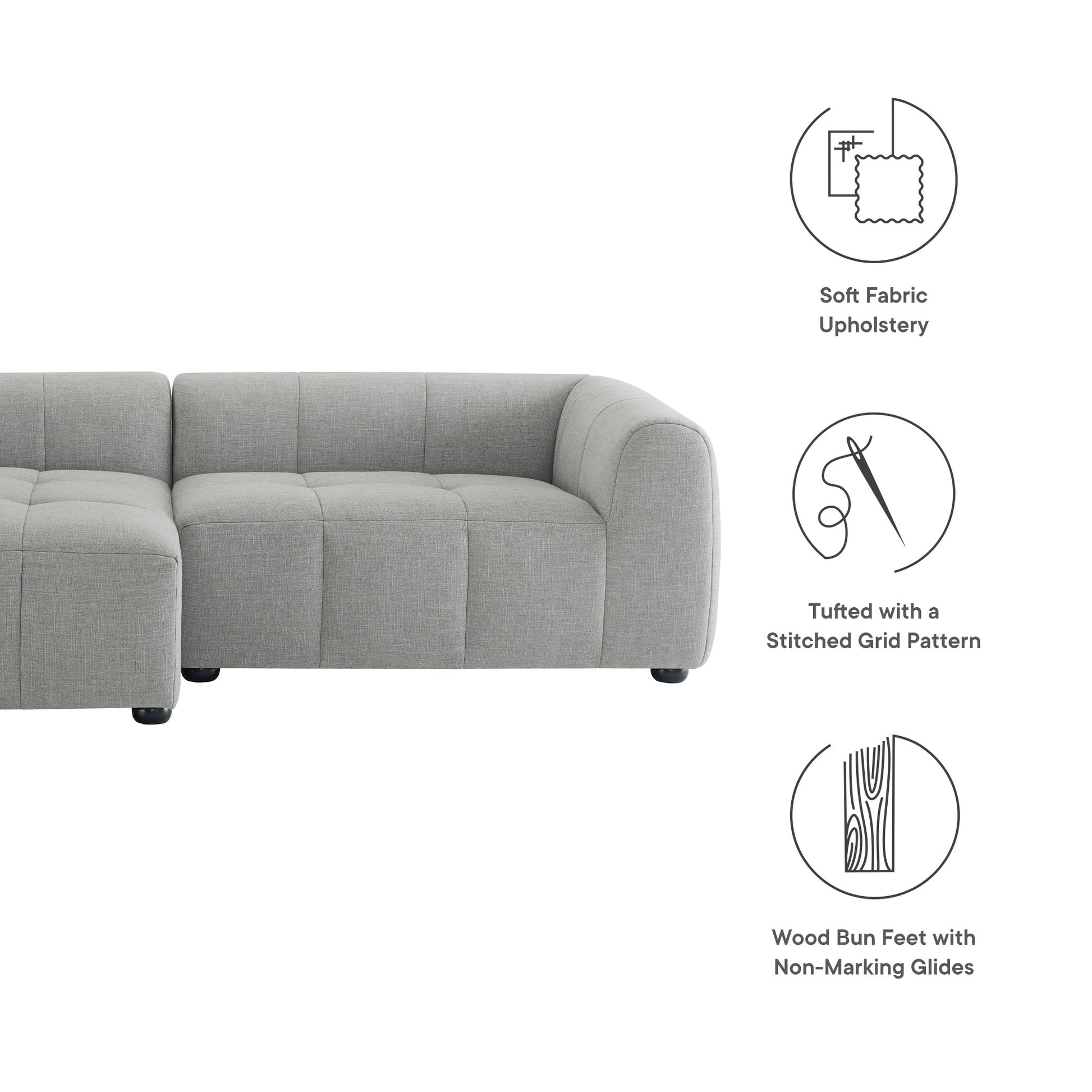Light gray fabric modular sectional sofa with tufted stitched grid pattern cushions and wood bun feet with non-marking glides.