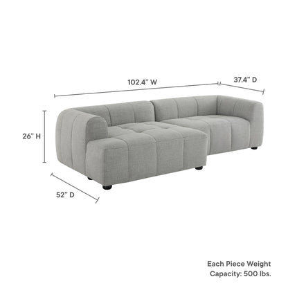 Gray fabric L-shaped modular sectional with tufted cushions and rounded arms.