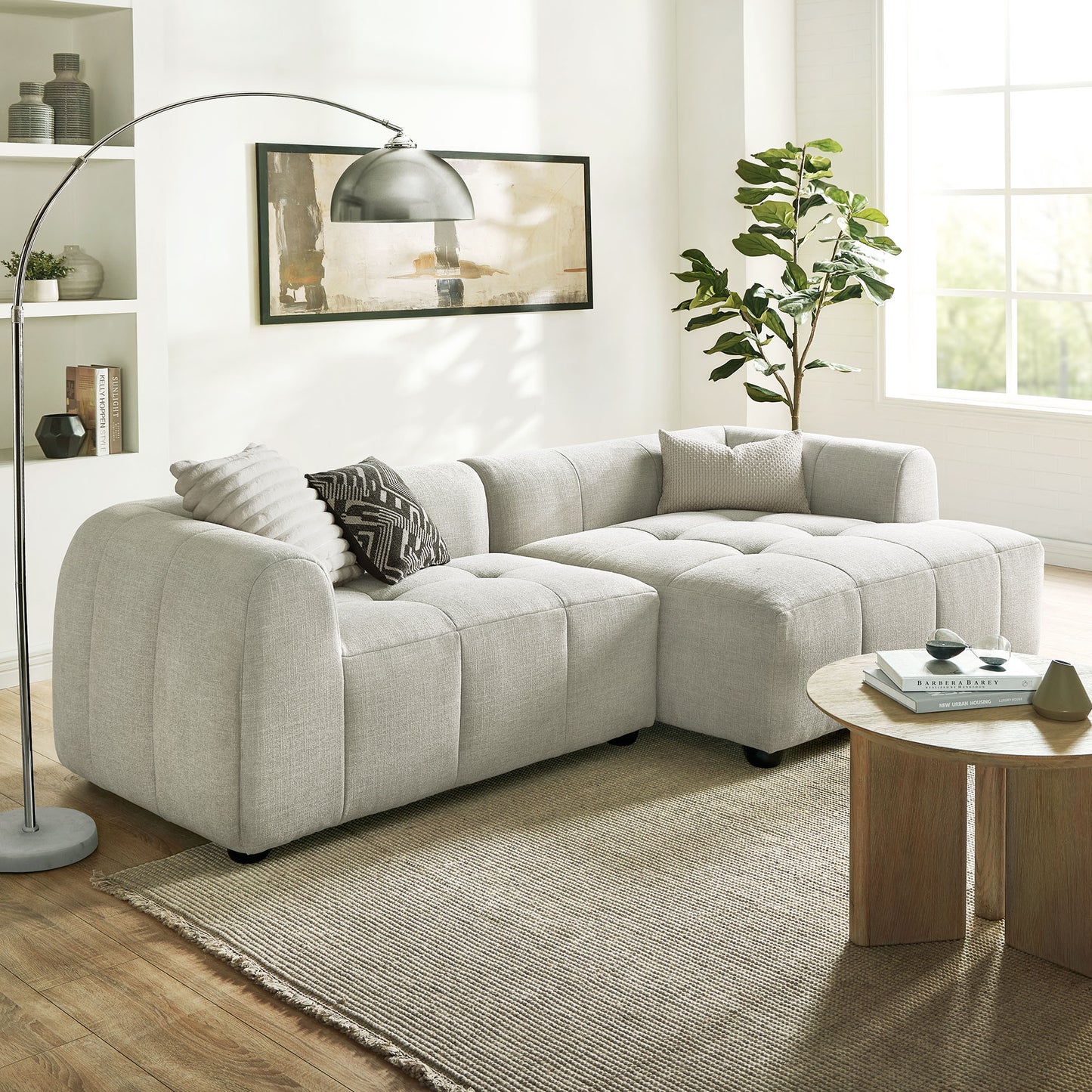 White right-facing upholstered fabric modular sofa with chaise in a bright living room.