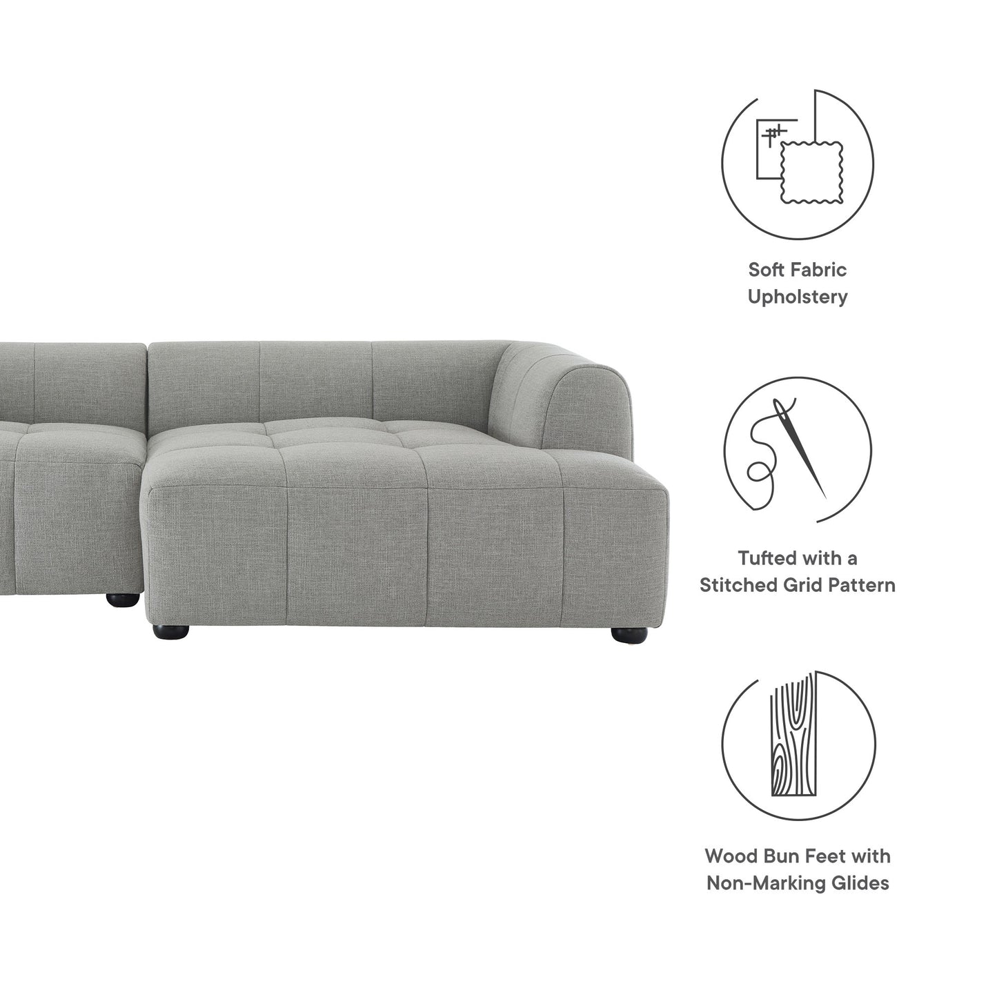 Pewter grey fabric modular sectional sofa with tufted grid cushions and wood bun feet.