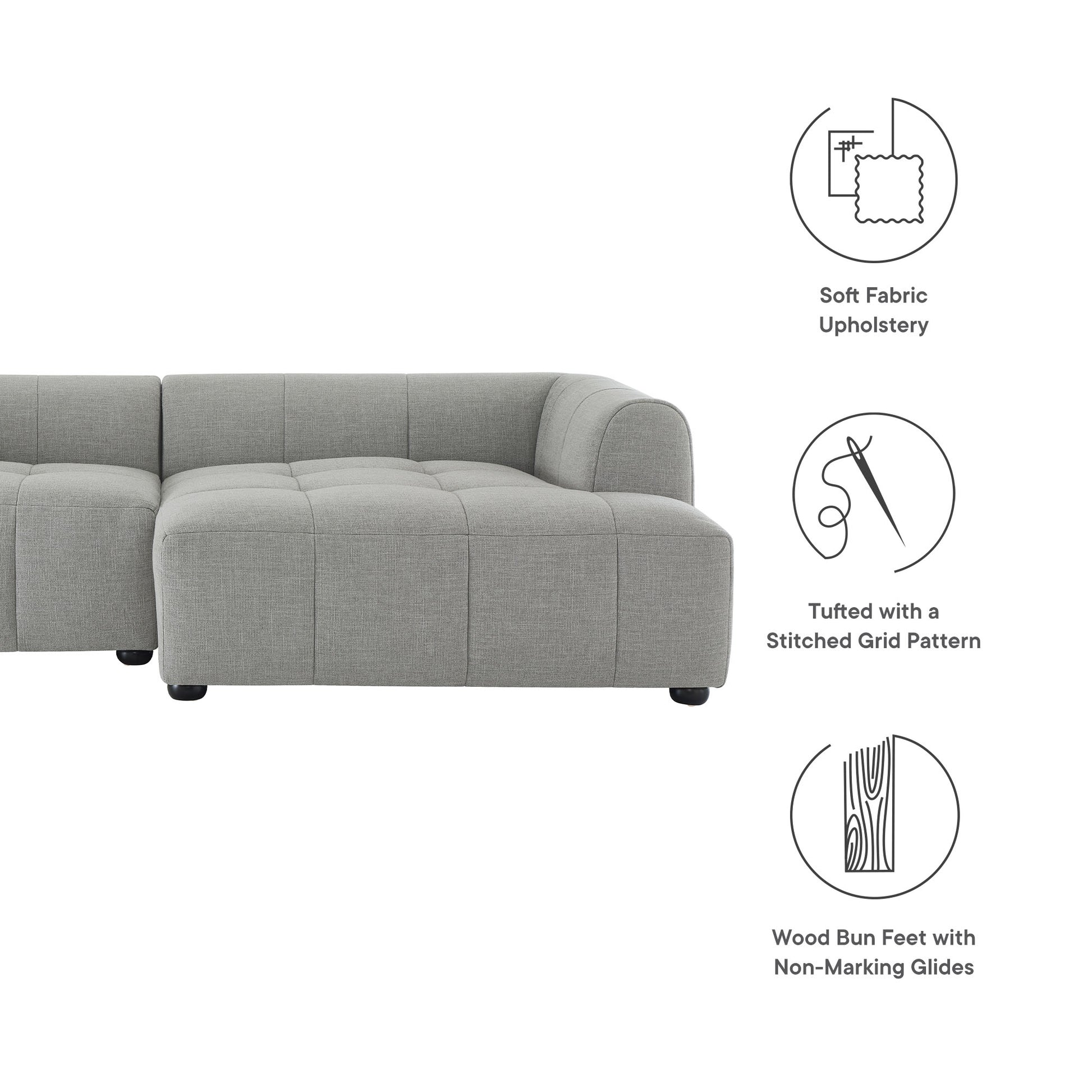 Pewter grey fabric modular sectional sofa with tufted grid cushions and wood bun feet.