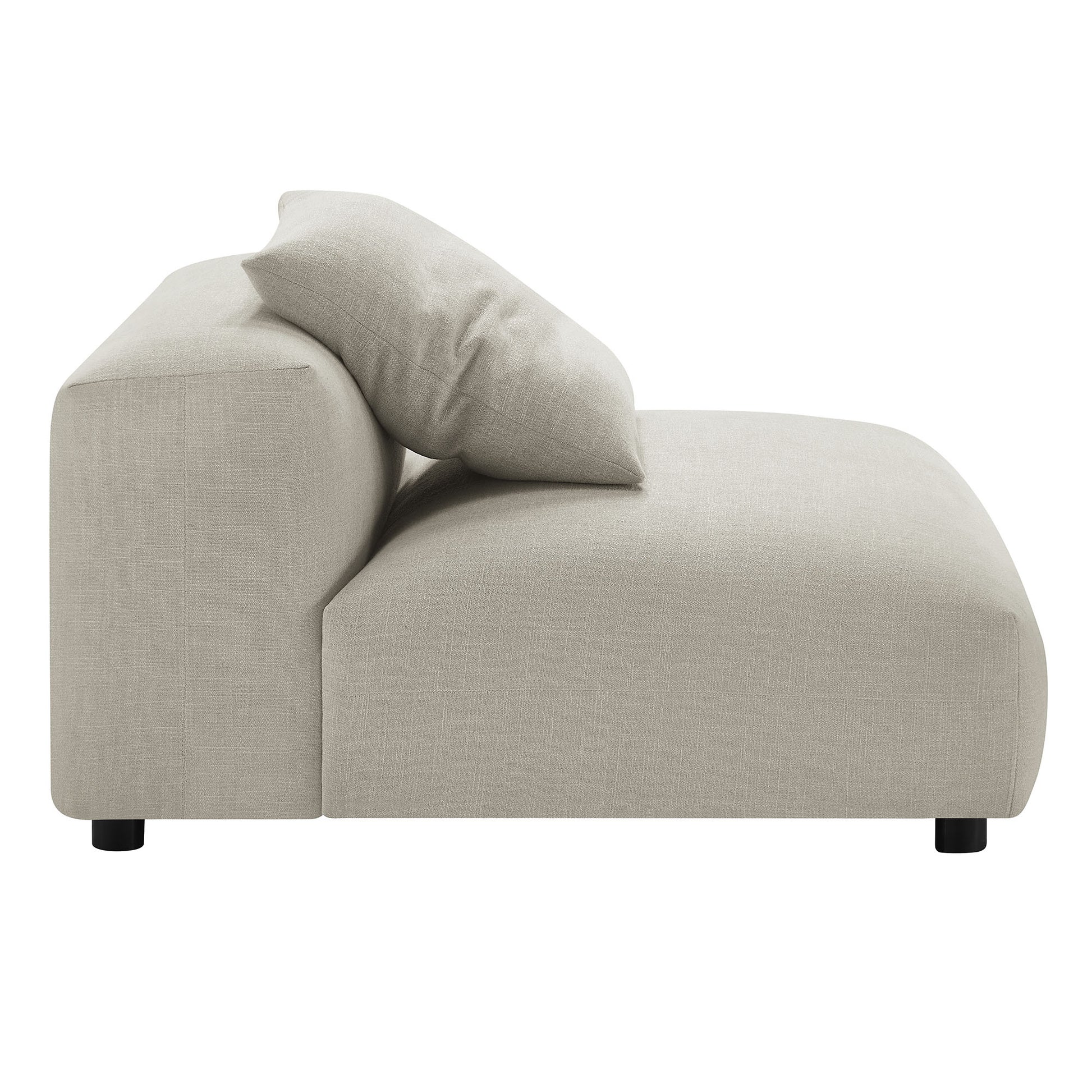 Beige linen armless upholstered chair with a low profile and black feet.