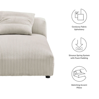 Almond corduroy upholstered armless chaise lounge with ribbed texture and a low-profile rounded silhouette, plus a matching accent pillow
