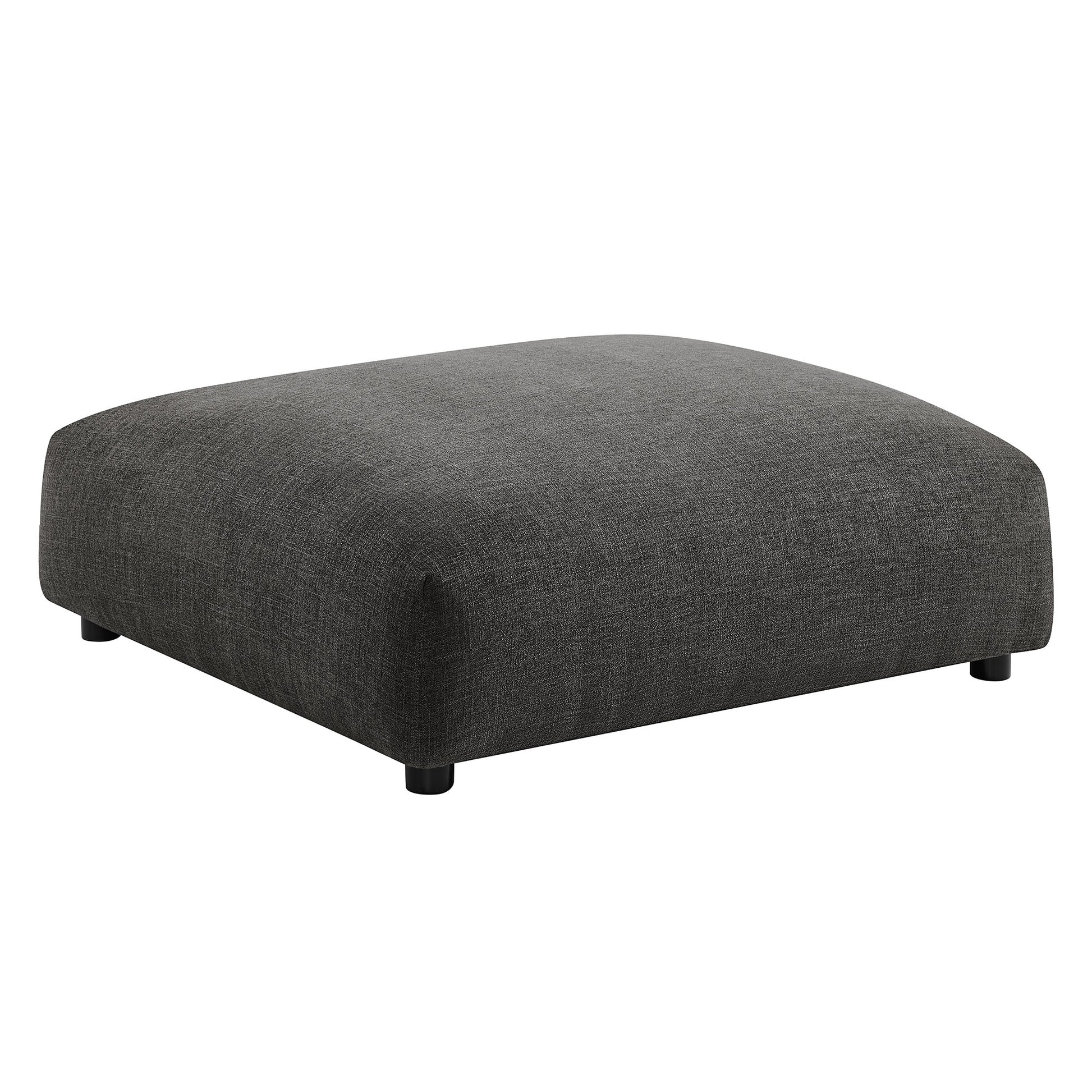 Charcoal gray fabric ottoman with rounded edges, low profile, rectangular shape and short black feet.
