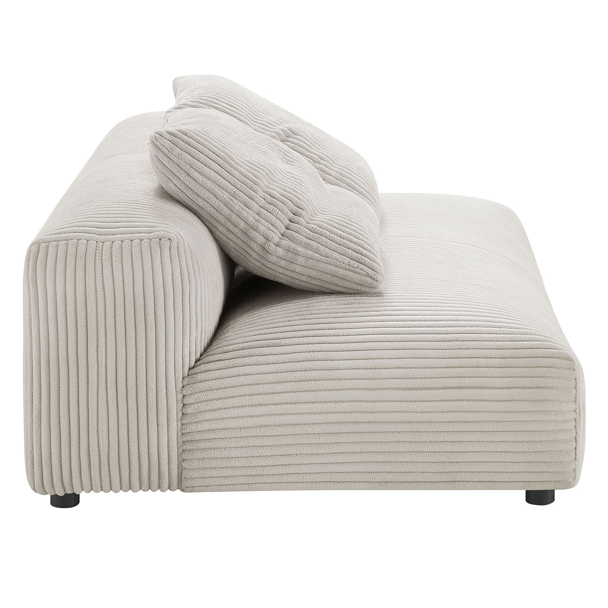 Almond corduroy modular sectional with chaise, ribbed texture, low-profile silhouette, two matching cushions, short black legs.