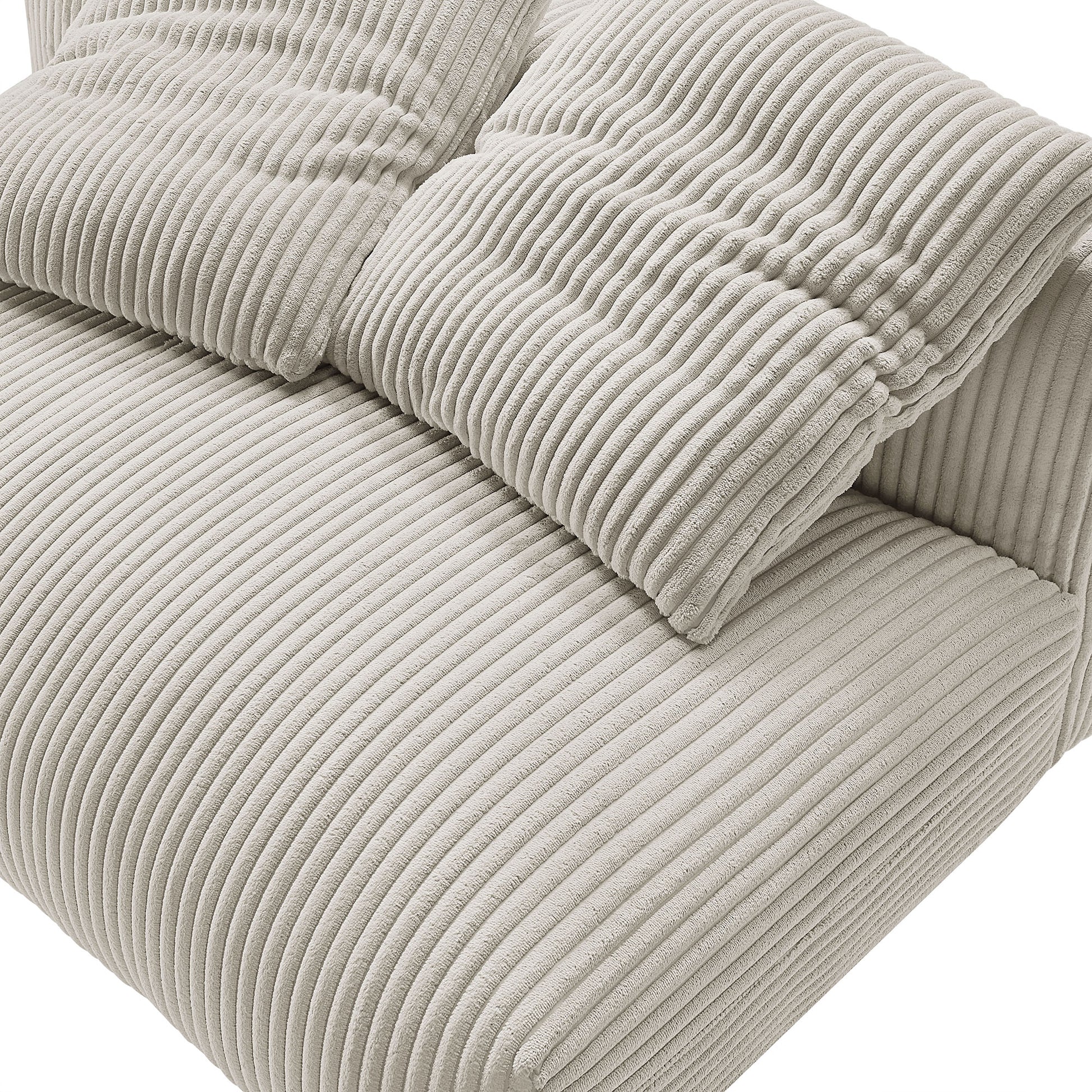 Two brown corduroy throw pillows with vertical ribbed texture on a plush loveseat.