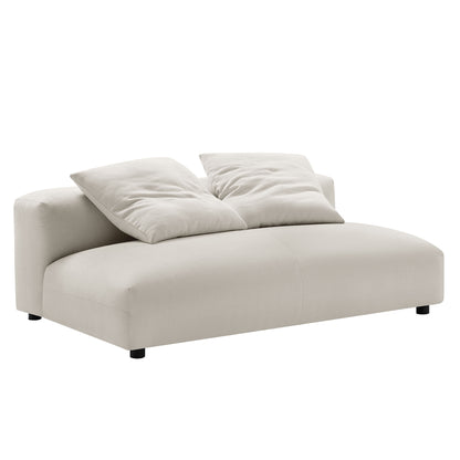 Gray fabric armless loveseat with ottoman in a modular set; two plush cushions, rounded edges, low-profile contemporary style.