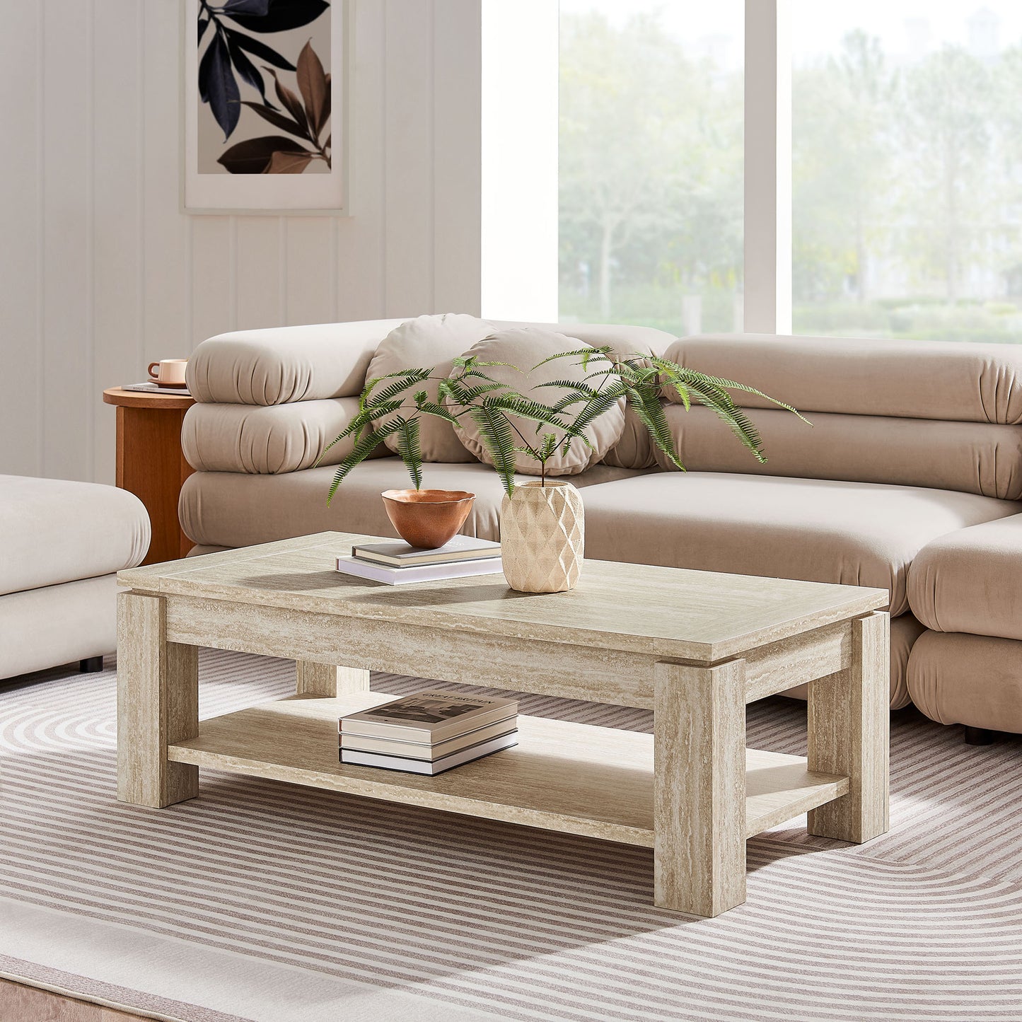 Travertine rectangular coffee table with lower shelf; beige sectional sofa, striped rug, and plant in a bright living room.