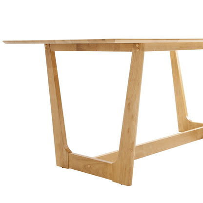Natural wood dining table with trestle A-frame legs and long rectangular top.
