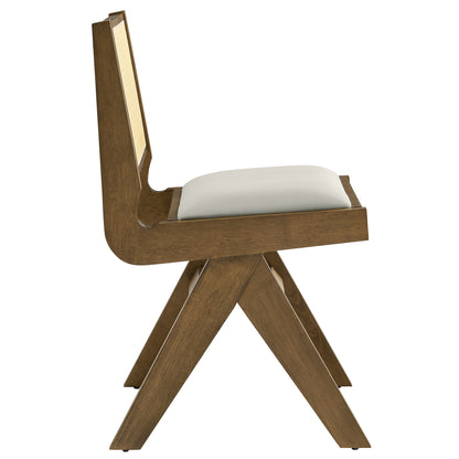 Pair of dining chairs with gray vegan leather seats and cane backs, featuring X-shaped legs.