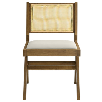 Pair of gray dining chairs with cane backs and vegan leather seats.