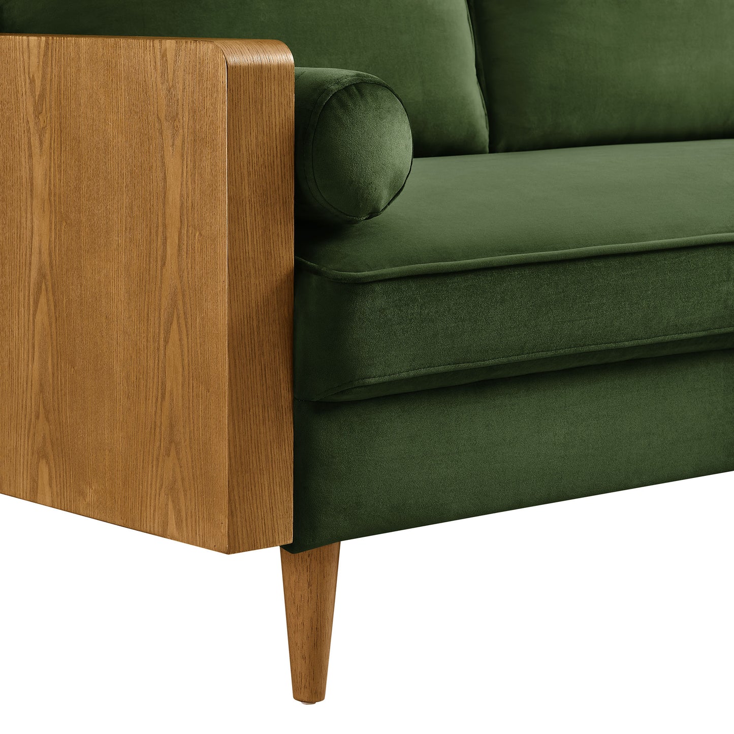 Green velvet sofa with natural wood armrest, tapered legs, and a cylindrical bolster pillow.