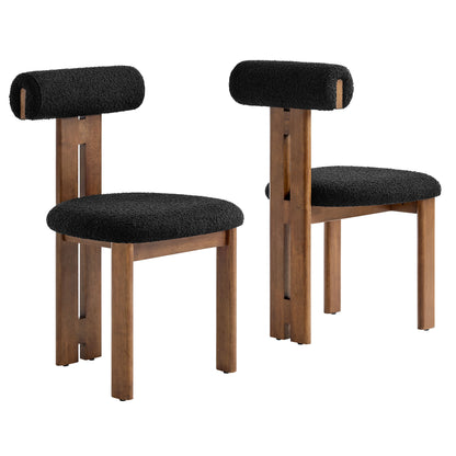 Pair of walnut-finish wooden chairs with black fabric round seats & cylindrical back cushions.