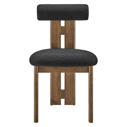 Walnut wood-framed dining chair with black boucle fabric upholstery and small padded backrest.
