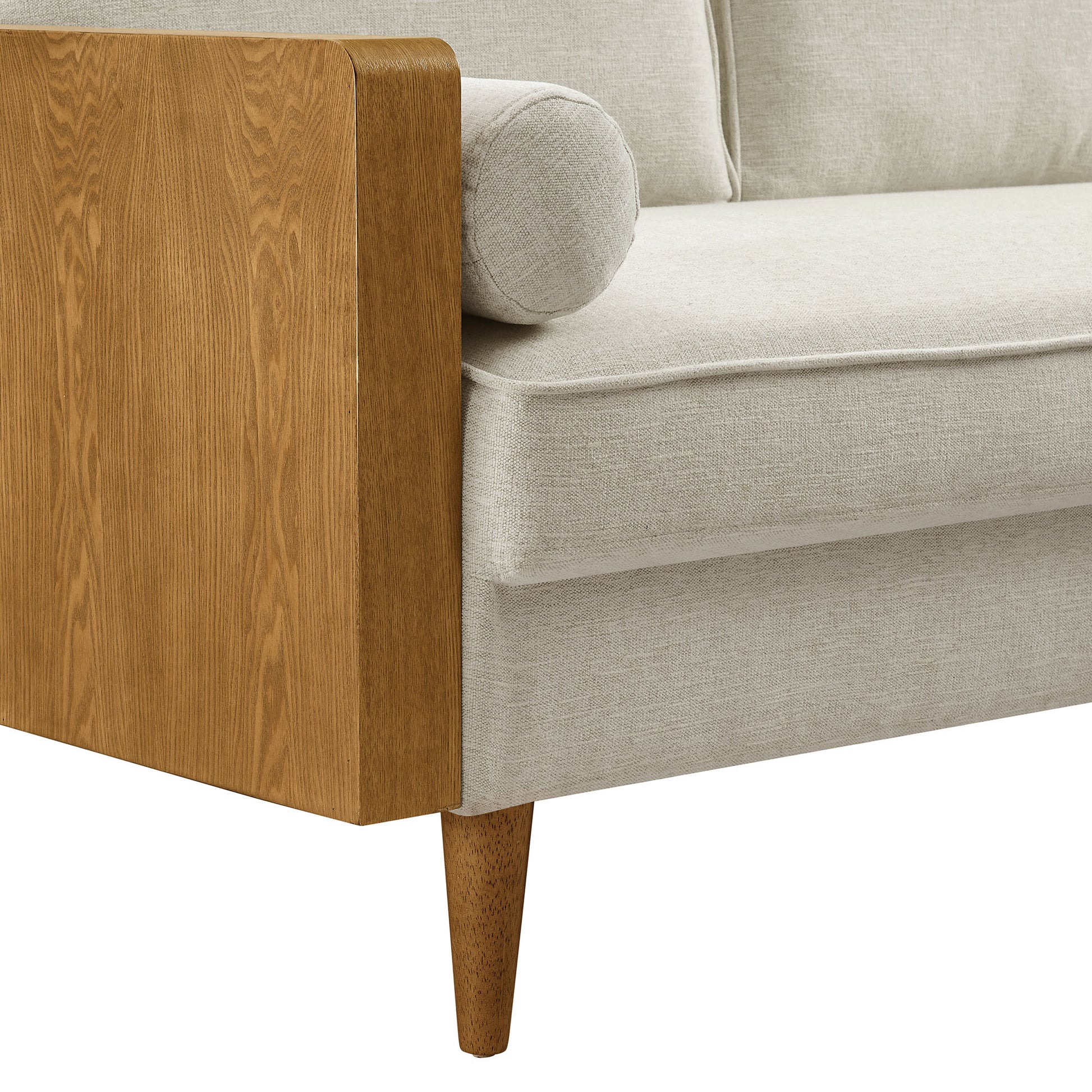 Beige fabric sofa with walnut wood arm panel, bolster roll, and tapered wooden legs.