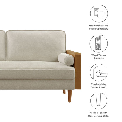 Kellan sofa in heathered beige fabric with walnut veneer armrests, two matching bolster pillows, and tapered wood legs.