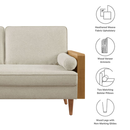 Brown heathered weave fabric loveseat with walnut wood veneer armrests, tapered wood legs, and a round bolster pillow.