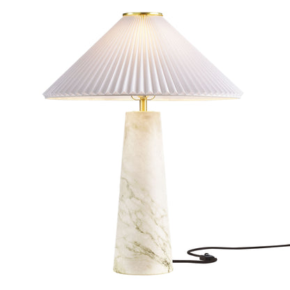 White pleated cone shade atop a marble-look tapered base with brass accents; decorative table lamp.