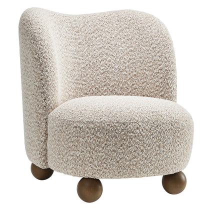 Beige boucle upholstered accent chair with curved back, rounded seat and four brown wooden ball feet.