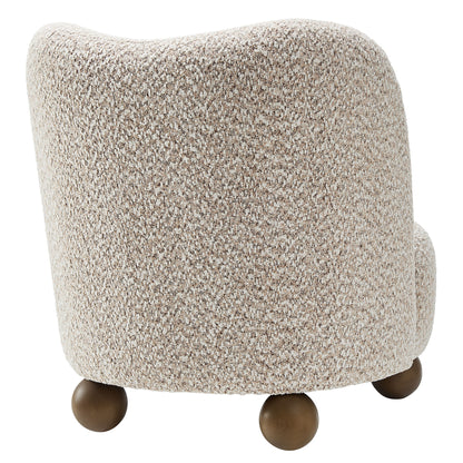 Brown boucle fabric accent chair with curved back and dark wood ball feet.
