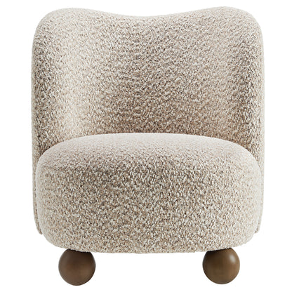Brown boucle accent chair with a rounded back and cushioned seat on dark wood ball feet.