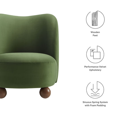 Olive-green velvet accent chair with walnut wooden feet, curved back, foam-padded sinuous spring system.