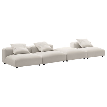 Gray fabric modular sectional sofa with four connected seats and plush pillows, low-profile legs.