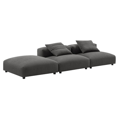 Dark gray fabric modular sectional sofa with chaise on left & coordinating cushions, low black legs.