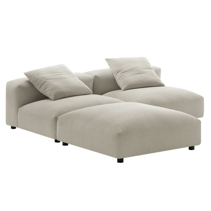 Brown fabric sectional sofa with chaise and low-profile black legs, two matching throw pillows.