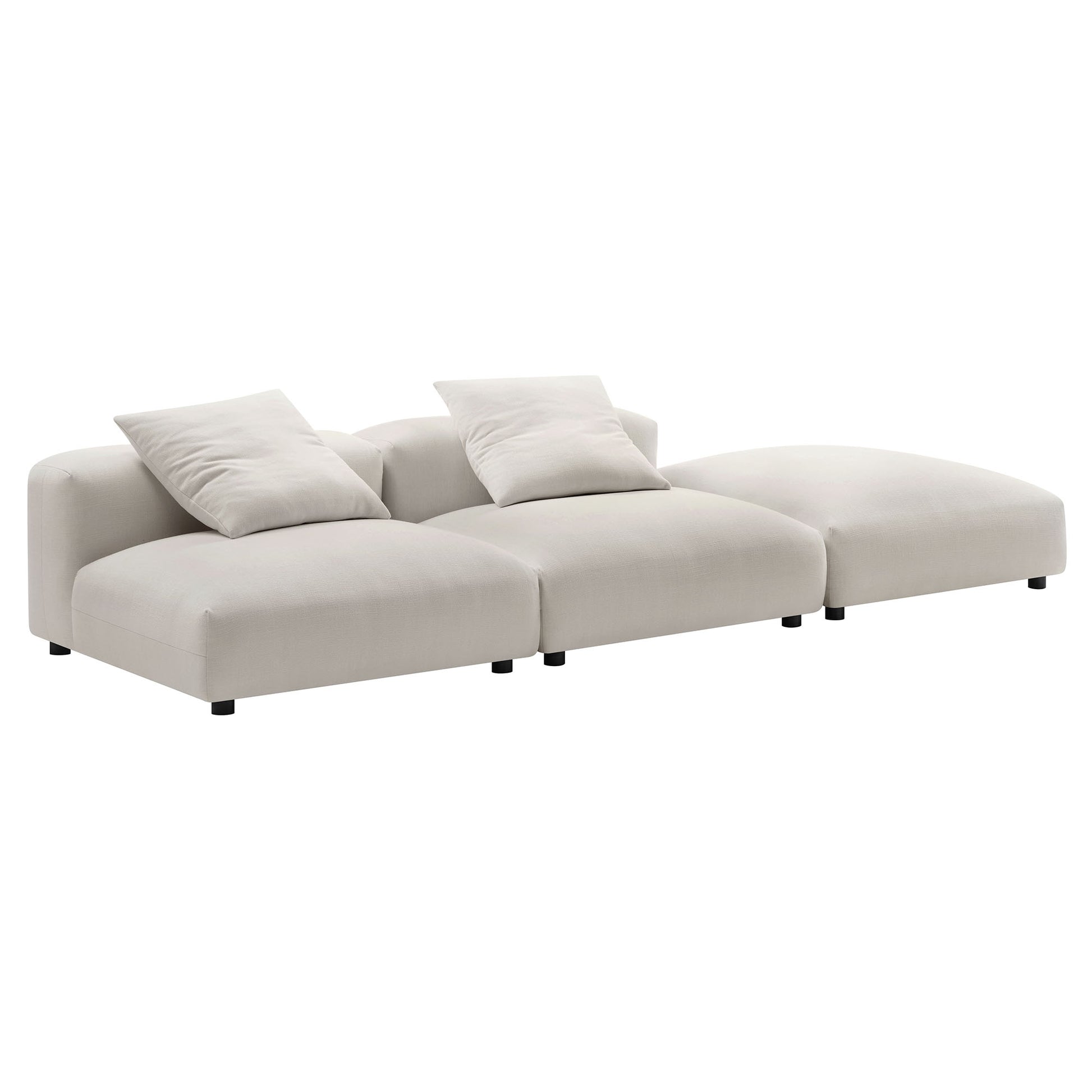 Brown fabric modular sectional with chaise end, two throw pillows, low black legs.