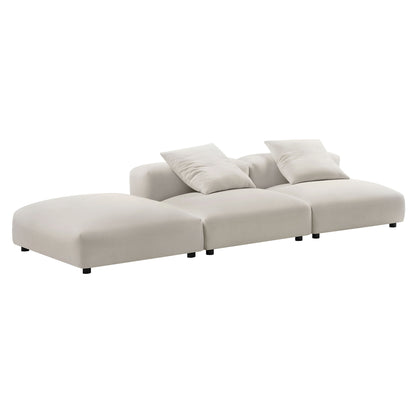 Brown fabric modular sectional with chaise on the left, three-seat modules, two back cushions, and low black legs.