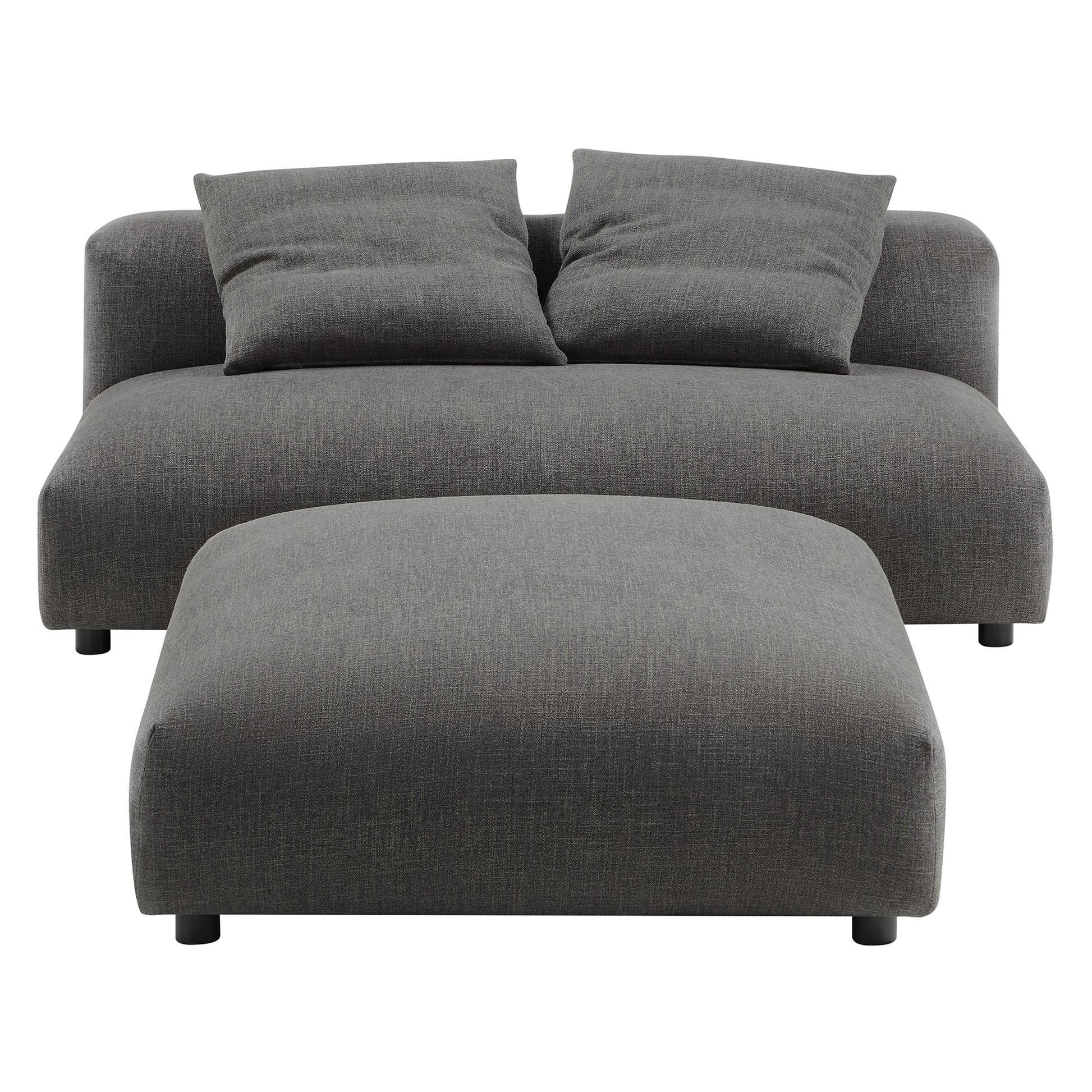 Charcoal gray fabric armless loveseat with matching ottoman, two back cushions, low-profile legs.
