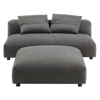 Charcoal gray fabric armless loveseat with matching ottoman, two back cushions, low-profile legs.