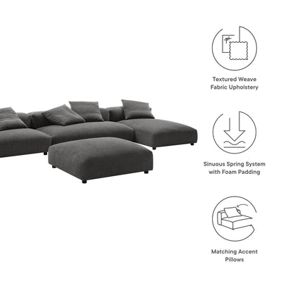 Charcoal gray sectional sofa with ottoman in textured weave fabric, matching accent pillows.